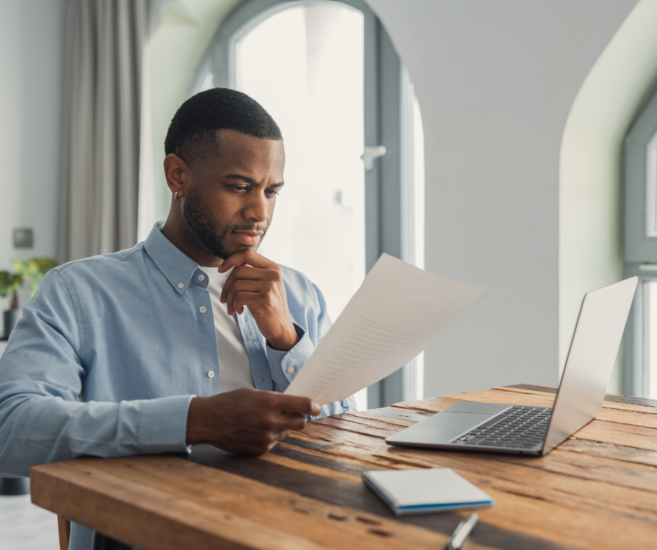 Man looking through his cv trying to figure out how to make your CV stand out
